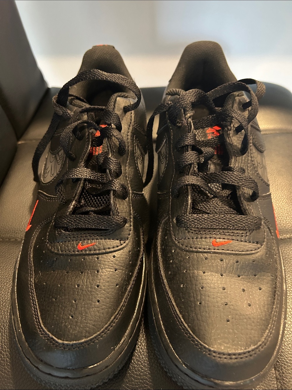 Nike Black Sneakers with Red Swoosh Details